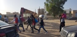 FILE - Migrants march toward the offices of international organizations to demand help traveling to Europe after Libyan police agreed to meet their demand for release from a bombed-out facility, in Tripoli, Libya, July 9, 2019. (H.Murdock/VOA)