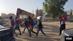 Migrants march towards the offices of international organizations to demand help traveling to Europe after Libyan police agreed to meet their demand for release from the bombed-out facility, in Tripoli, Libya, July 9, 2019. (H.Murdock/VOA)