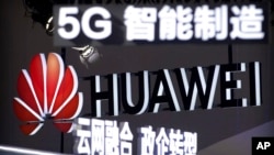 FILE - Signs promote 5G wireless technology from Chinese firm Huawei at an expo in Beijing, Sept. 26, 2018. Germany announced July 11, 2024, the country will ban the use of components made by Chinese companies Huawei and ZTE from core parts of its 5G networks beginning in 2026.