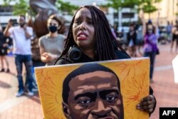 A woman reacts as she marches during an event in remembrance of George Floyd in Minneapolis, Minnesota, on May 23, 2021.