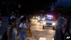 People cross a street during a blackout in Caracas, Venezuela, July 22, 2019. 