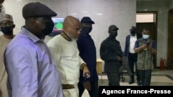 FILE - The Nigeria State Secret Police escort separatist leader Nnamdi Kanu, second from left, outside the Federal High Court in Abuja, Nigeria, on Oct. 21, 2021. 