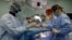 FILE - A medical team performs hernia surgery in an operating room near Riohacha, Colombia, Nov. 27, 2018. 