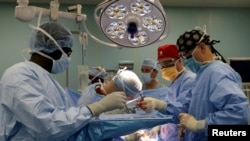 FILE - A medical team performs hernia surgery in an operating room near Riohacha, Colombia, Nov. 27, 2018. 