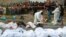 Bodies in body bags are placed on the side of the road after an accident in Tuxtla Gutierrez, Chiapas state, Mexico, Dec. 9, 2021.