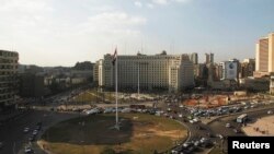 Egypt's national flag is seen raised at the top of a flag pole, which was recently installed in Tahrir square, in central Cairo, Feb. 8, 2015. 