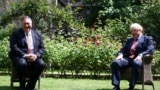 Britain's Prime Minister Boris Johnson, right, welcomes U.S. Secretary of State Mike Pompeo to Downing Street, London, ahead of a private meeting, July 21, 2020. 