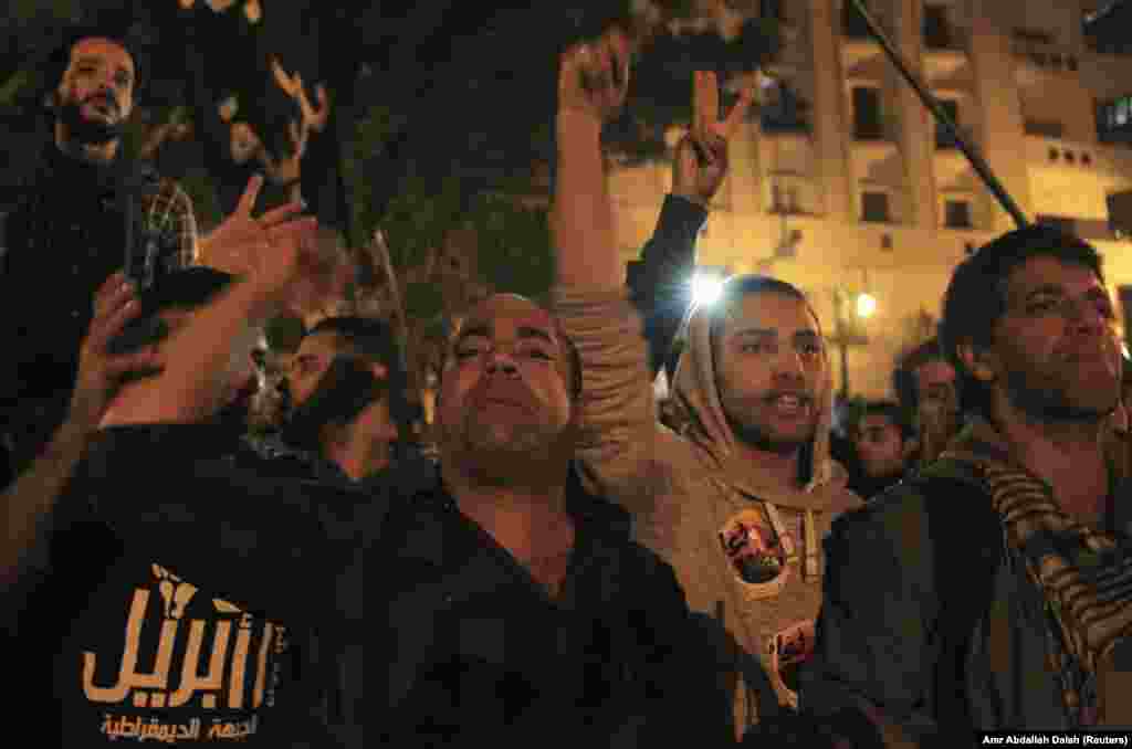 Activists and anti-government protesters shout slogans against the military and interior ministry during a rally against a new law restricting demonstrations, in front of Egypt's Parliament in Cairo November 27, 2013.