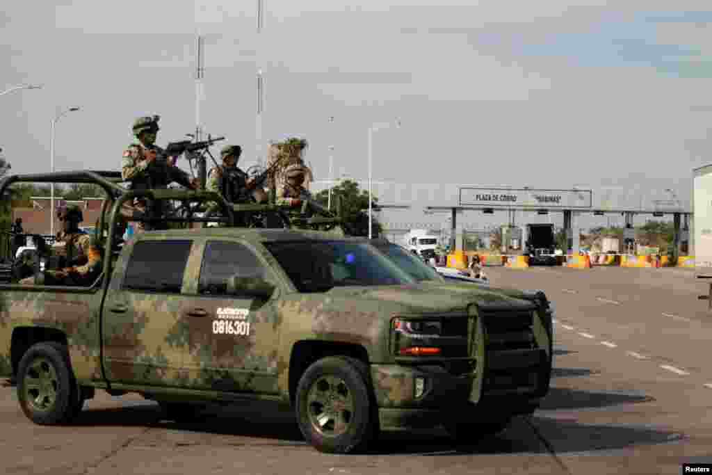 Soldiers keep watch the area during a security operation to prevent kidnapping and assaults on travelers on their way through the Monterrey-Nuevo Laredo highway in Sabinas Hidalgo, on the outskirts of Monterrey, Mexico, June 27, 2021.