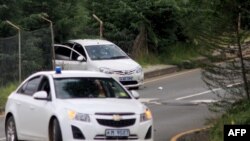 A image shows a blood stained car riddled with bullets (back) following a shoot-out near the Royal Palace in Maseru on Feb. 1, 2015, after the All Basotho Convention (ABC) rally. 