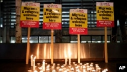 Signs and candles on a wall were placed at a vigil for the 39 truck victims, outside the Home Office in London, Oct. 24, 2019.