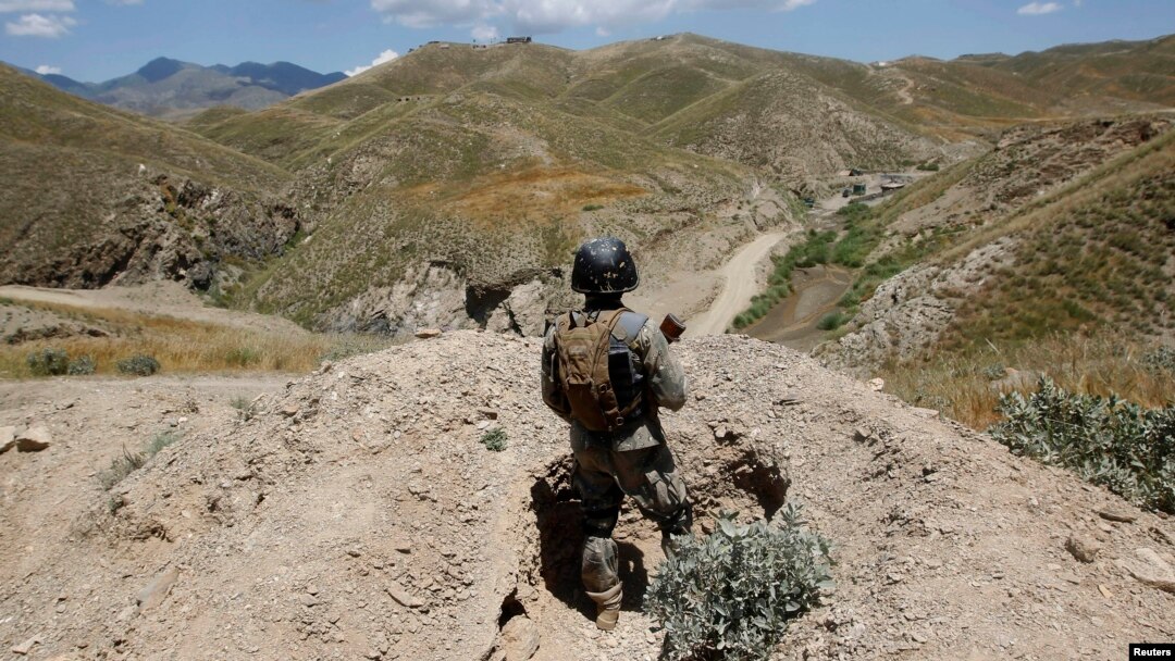 FILE - An Afghan border policeman is seen patrolling a section of the frontier between Afghanistan and Pakistan.