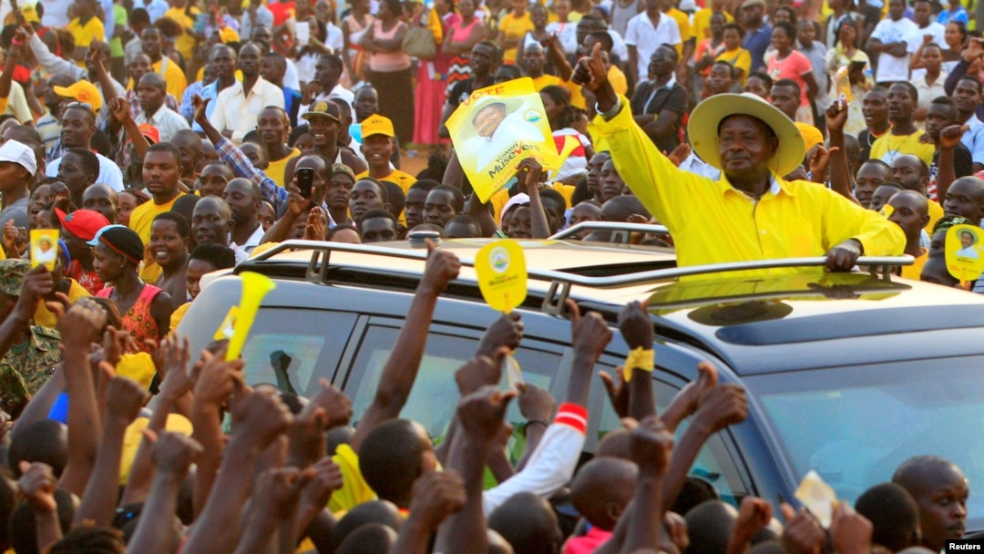 FILE - Uganda's president and presidential candidate Yoweri Museveni of the ruling party National Resistance Movement waves to his supporters as he arrives at a campaign rally in Entebbe, Uganda, Feb. 10, 2016.
