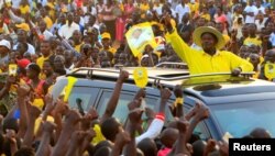 FILE - Uganda's president and presidential candidate Yoweri Museveni of the ruling party National Resistance Movement waves to his supporters as he arrives at a campaign rally in Entebbe, Feb. 10, 2016.