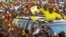 FILE - Uganda's president and presidential candidate Yoweri Museveni of the ruling party National Resistance Movement waves to his supporters as he arrives at a campaign rally in Entebbe, Uganda, Feb. 10, 2016.