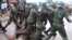 Guinean police arrest a protester on September 28, 2009 in front of the biggest stadium in the capital Conakry during a protest banned by Guinea's former ruling junta.