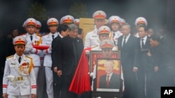 A member of Vietnam's armed forces carries a portrait of the late general secretary of the Communist Party Nguyen Phu Trong during his funeral in Hanoi on July 26, 2024. U.S. Secretary of State Antony Blinken visited Hanoi on July 27 to pay his respects.