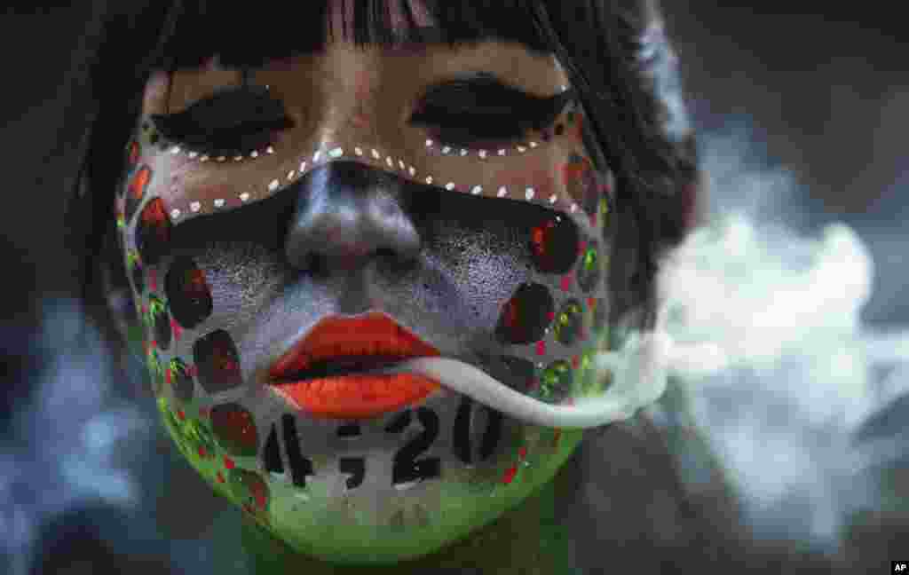 Ana Mendez Casteñeda smokes marijuana during &quot;Fumaton 420&quot; outside the national Senate in Mexico City, April 20, 2021.