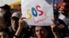 FILE - Venezuelan nationals attend a protest against the official results that declared President Nicolas Maduro the winner of the July presidential election, in Quito, Ecuador, Aug. 17, 2024.