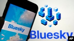 FILE - The app for Bluesky is shown on a mobile phone, left, and on a laptop screen on June 2, 2023, in New York.