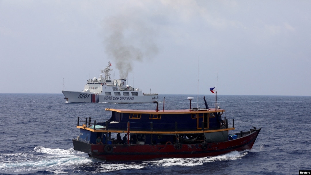 Sebuah kapal pasokan Filipina berlayar di dekat kapal Penjaga Pantai China di Laut China Selatan, 4 Oktober 2023. (Foto: REUTERS/Adrian Portuga)