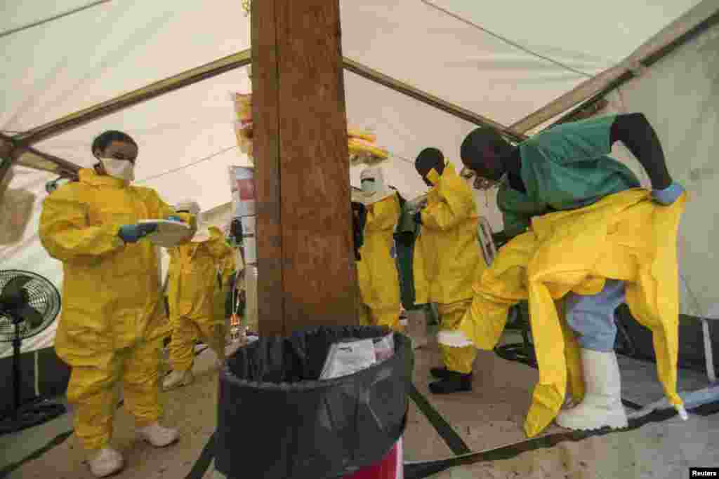 Medical staff working with Medecins Sans Frontieres (MSF) put on their protective gear before entering an isolation area at the MSF Ebola treatment center, in Kailahun, Sierra Leone, July 20, 2014.&nbsp;