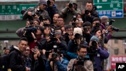 FILE - Journalists follow Tsai Ing-wen, then a presidential candidate, as she campaigns in Taipei, Jan. 13, 2016.