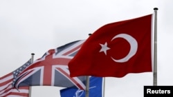 FILE - A Turkish flag (R) flies among others flags of NATO members during a North Atlantic Council meeting alliance headquarters in Brussels, Belgium, July 28, 2015.