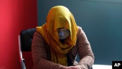 FILE - A female TV presenter from southern Afghanistan conceals her identity for security reasons as she is being interviewed by the Associated Press in Kabul, Afghanistan, Feb. 3, 2021.