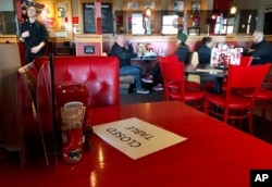 A Red Robin reastaurant in Tigard, Ore., has closed some tables in order to maintain "social distancing" between diners per CDC guidelines, March 15, 2020.