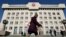 FILE - A Mongolian man walks along Ulan Bator's vast central square near the parliament building in Mongolia.
