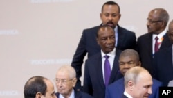 Ethiopian Prime Minister Abiy Ahmed, top center, looks as Egyptian President Abdel-Fattah el-Sissi, bottom left, and Russian President Vladimir Putin, bottom right, at the Russia-Africa summit in the Black Sea resort of Sochi, Russia, Oct. 24, 2019. 