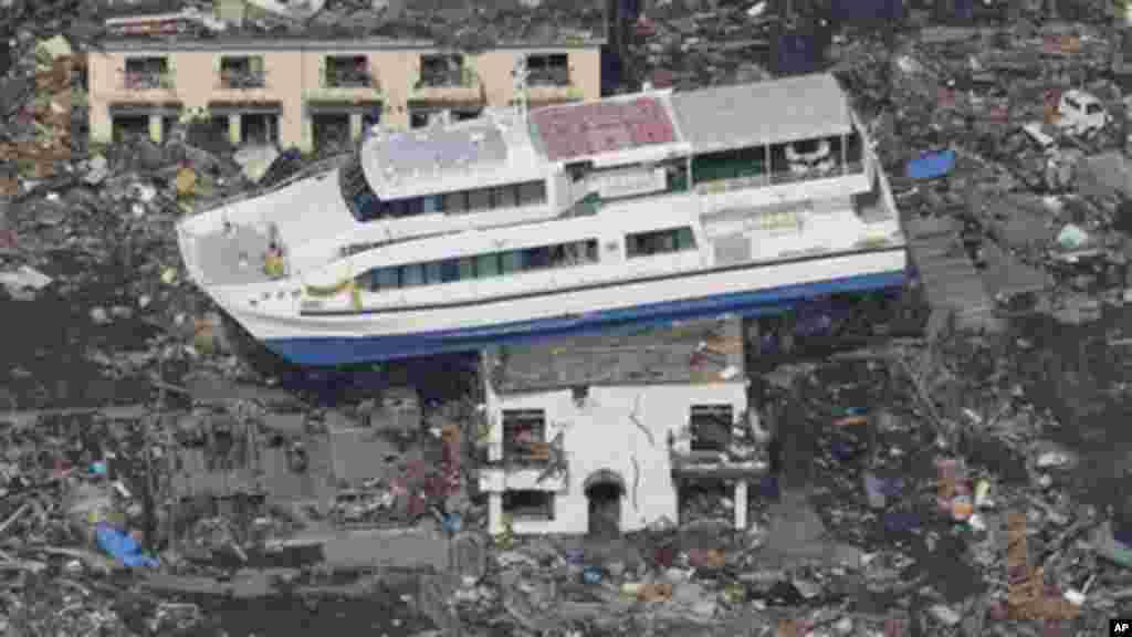 A ferry stranded on a building is seen in Otsuchi, Iwate Prefecture, northern Japan, Sunday, March 13, 2011, two days after a powerful earthquake-triggered tsunami hit the country's east coast.