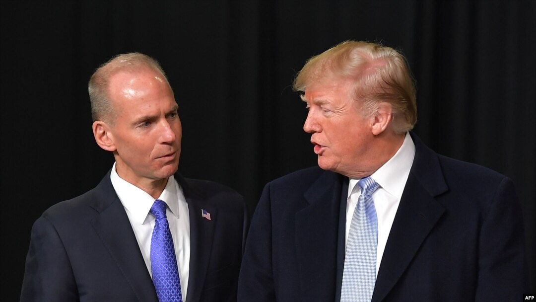In this file photo taken on March 14, 2018, President Donald Trump speaks with Boeing CEO Dennis Muilenburg during a tour of the Boeing Company in St. Louis, Missouri. 