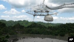 FILE - This July 13, 2016 file photo shows one of the largest single-dish radio telescopes at the Arecibo Observatory in Arecibo, Puerto Rico.