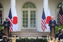 FILE - Japan's Prime Minister Yoshihide Suga and U.S. President Joe Biden hold a joint news conference in the Rose Garden at the White House in Washington, April 16, 2021.