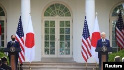 Japan's Prime Minister Yoshihide Suga and U.S. President Joe Biden hold a joint news conference in the Rose Garden at the White House in Washington, April 16, 2021. 