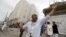 People react at the site of a Saudi-led coalition airstrike in Sana'a, Yemen, April 8, 2015. 