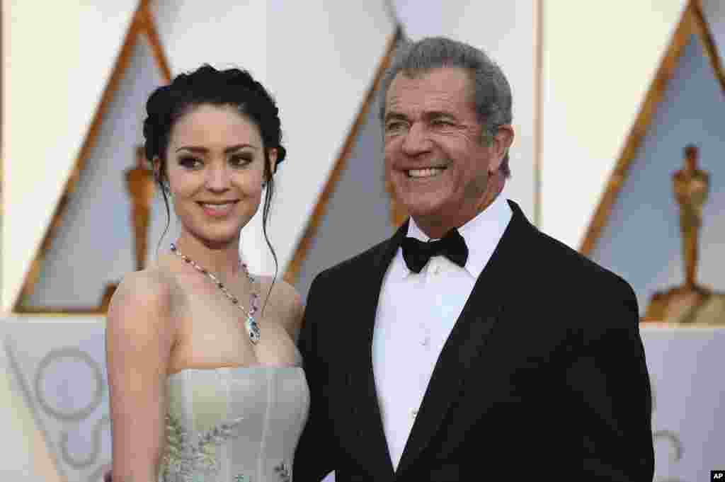 Rosalind Ross, left, and Mel Gibson arrive at the Oscars on Sunday, Feb. 26, 2017, at the Dolby Theatre in Los Angeles. 