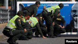 Colombian police protect themselves during clashes between opposition supporters and Venezuela's security forces at Simon Bolivar bridge on the border line between Colombia and Venezuela as seen from Cucuta, Colombia, Feb. 25, 2019. 