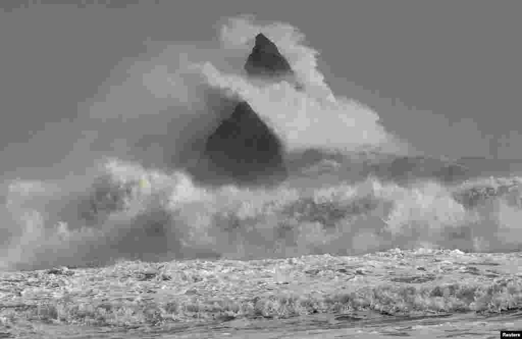 Large waves crash over Church Rock as hurricane force winds reach the coastline at Broad Haven, Pembrokeshire, Wales, Britain.