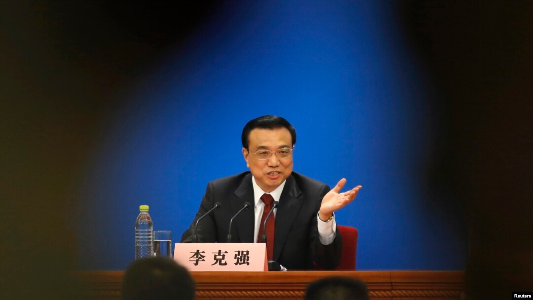 China's newly-elected Premier Li Keqiang gestures during his news conference in Beijing, March 17, 2013.