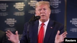 FILE - U.S. President Donald Trump gestures as he holds a news conference at the 50th World Economic Forum iin Davos, Switzerland, Jan. 22, 2020.