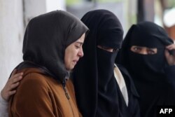 FILE —Palestinians mourn for relatives who were killed in overnight Israeli air strikes on the Rafah refugee camp in the southern Gaza Strip, at Rafah's Najjar hospital on February 27, 2024.