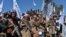 Afghan Taliban militants and villagers attend a gathering as they celebrate the peace deal in the Afghan conflict with the U.S. in Afghanistan, in Alingar district of Laghman Province on March 2, 2020. 