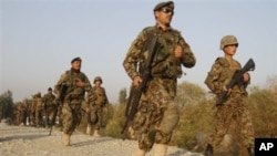 Afghan National Army soldiers rush towards the site of a gunbattle near the Jalalabad military air base in Jalalabad, east of Kabul, Afghanistan, 13 Nov 2010