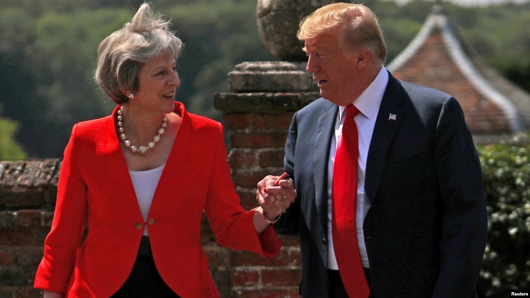 FILE - Britain's Prime Minister Theresa May and U.S. President Donald Trump walk to a joint news conference at Chequers, the official country residence of the prime minister, near Aylesbury, Britain, July 13, 2018.