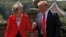 FILE - Britain's Prime Minister Theresa May and U.S. President Donald Trump walk to a joint news conference at Chequers, the official country residence of the prime minister, near Aylesbury, Britain, July 13, 2018.