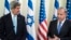 U.S. Secretary of State John Kerry listens as Israeli Prime Minister Benjamin Netanyahu makes a statement to the press before a meeting in Jerusalem on January 2, 2014. 