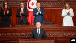 In this photo provided by the Tunisian Presidency, Tunisia's President Kais Saied is applauded after taking oath October 21, 2024 in Tunis following his reelection. 